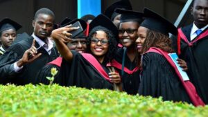 University of National students pose for a selfie after graduation.